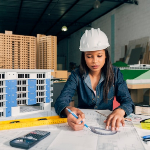 fpkdl.com_960_images_fpkdl.com_960_african-american-lady-safety-helmet-working-near-model-building_23-2148039862